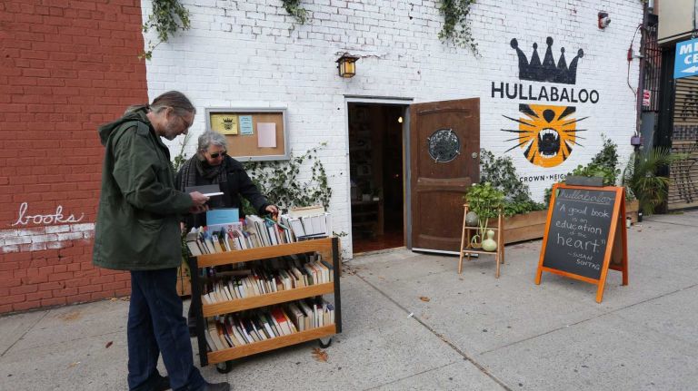 Michael Donnelley and Monica Berger browse at Hullabaloo bookstore on Park Place near the corner of Franklin Avenue. (Oct. 25, 2013)