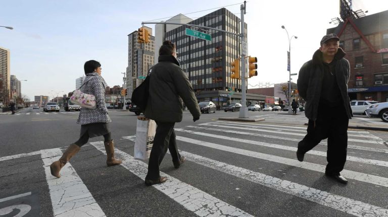 Pedestrians on Queens Boulevard at 71st Avenue. (Nov. 30, 2013)