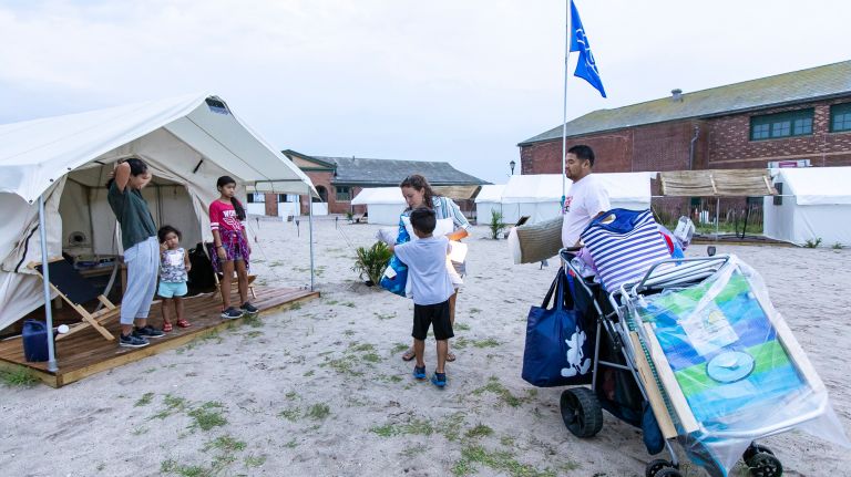 The Jalosjos family of New Jersey moves into the tent that will become home across three days at Camp Rockaway.