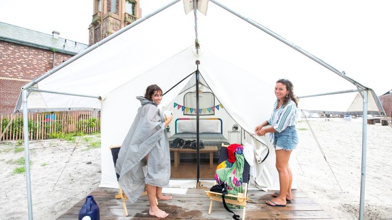Kate Neuman of Manhattan in her tent with Sophie Henderson, a co-manager of Camp Rockaway on Friday.