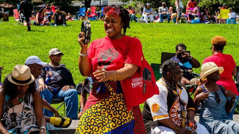 Sundae Sermon brings Harlem out to dance at St. Nicholas Park 19 A woman plays the tambourine to DJ Stormin Norman's tunes.