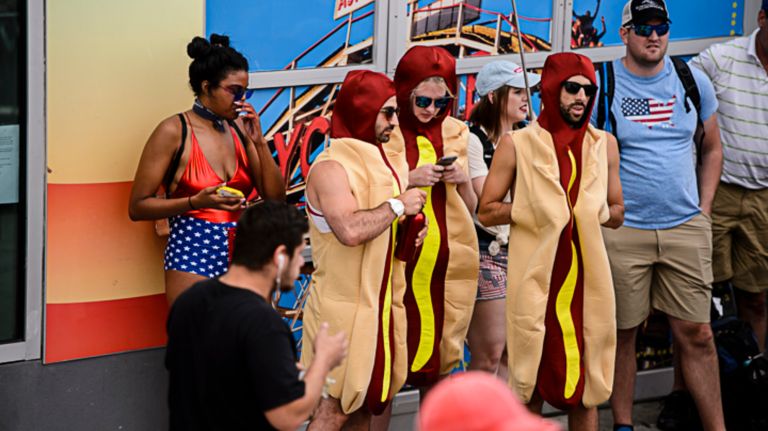 Nathan's Hot Dog Eating Contest 2017: Photos from the Coney Island event 25 Nathan's Famous Hot Dog Eating Contest spectators make a fashion statement as they await entry to the competition in Coney Island on Tuesday, July 4, 2017.