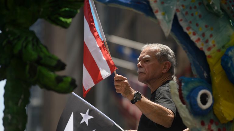 Oscar López Rivera rides on a float during the Puerto Rican Day Parade on Sunday, June 11, 2017.