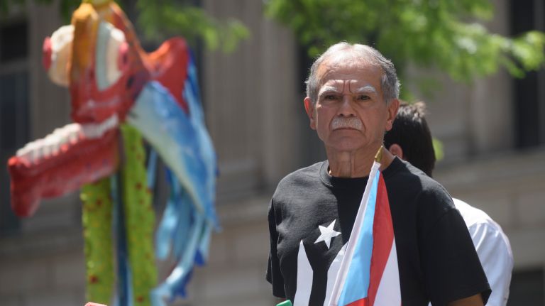 Spectators get ready to wave their flags as the 60th annual Puerto Rican Day Parade kicks off on Fifth Avenue in Manhattan on Sunday, June 11, 2017.