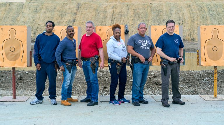 From left, Sgt. Steve Ward, Police Officer (PO) Timothy Broadus, Lt. James Darcy, PO Mary Lawrence, Counter Terrorism officer Steven Cohn, and Sgt. Thomas McLaughlin of the NYPD wear their revolvers as they pose for a photo at Rodman's neck gun range in the Bronx on May 30, 2018. They later trained on 9mm firearms as they prepare to retire their revolvers.