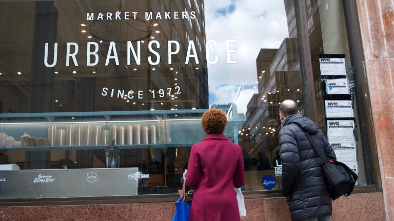 Tarps covering the windows of the food hall came down Friday, inviting curious passersby to peek in.