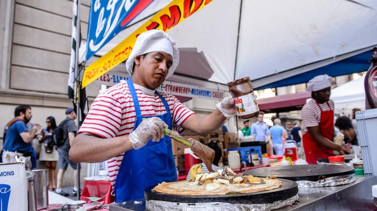 A chef makes crepes at the Bastille Day French themed street fair on East 60th Street between Fifth Avenue and Lexington Avenue, Sunday, July 9, 2017
