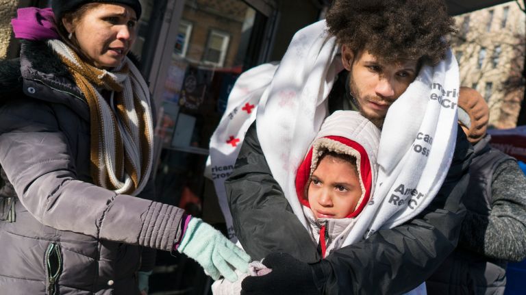 Fire in Belmont, Bronx: Photos from the scene 15 Crisbel Martinez, 10, is hugged by a family member, who escaped the fire with her, near their apartment building on Dec. 29, 2017.