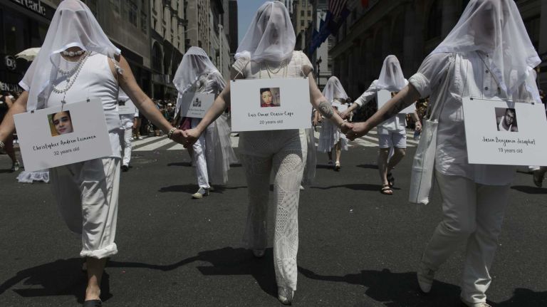 NYC Pride March 2016: See photos of the annual march to commemorate the Stonewall riots 97 Participants with photographs of Orlando shooting victims march in the New York City Pride March on Fifth Avenue in Manhattan on Sunday, June 26, 2016. This year's Pride parade pays tribute to the 49 killed in the shooting at a gay nightclub in Orlando, Florida, two weeks ago on June 12.
