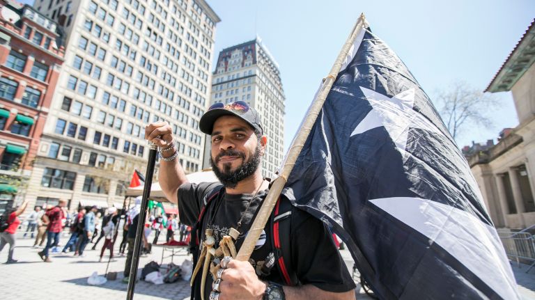 May Day protests: Photos of the NYC demonstrations 6 Joseph Rivera, a Puerto Rican native living in Brooklyn, holds a Puerto Rican Flag in distress at the May Day rally at Union Square in Manhattan on Tuesday, May 1, 2018.