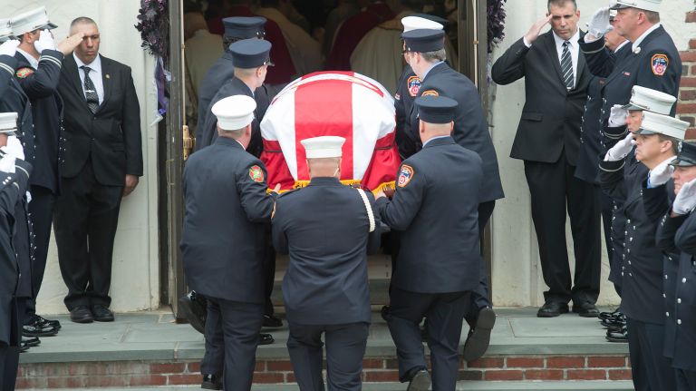 NYFD firefighter William N. Tolley's coffin is taken into St. Martin of Tours Roman Catholic Church in Bethpage on April 27, 2017