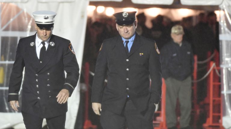 Firefighters, friends, and loved ones arrive in the heavy rain to gather and pay their respects at the wake for fallen FDNY firefighter William Tolley at Chapey and Sons Funeral home in Bethpage on April 25, 2017.