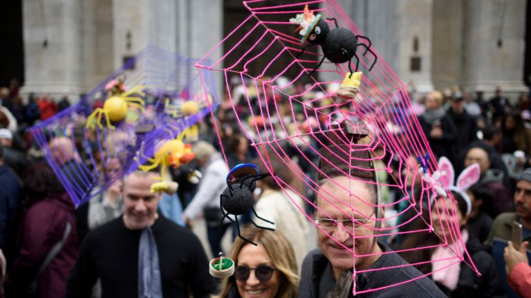 People with spider web hats gather on Fifth Avenue for the Easter parade and bonnet festival.