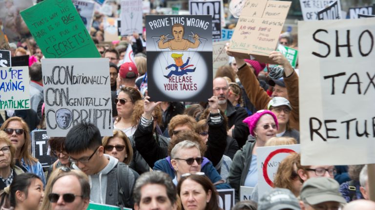 Protesters call on President Donald Trump to release his tax returns on Saturday, April 15, 2017. Similar marches were held on Long Island, Washington, D.C. and near Trump's estate in Palm Beach, Fla.