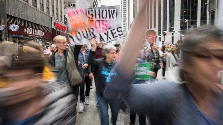 Protesters march up Sixth Avenue on Saturday, April 15, 2017, to call upon President Donald Trump to disclose his tax returns.
