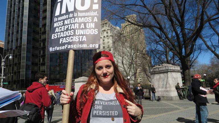 Lindsey Montague, 35, of Queens, holds a protest sign during the A Day Without a Woman rally in Manhattan on Wednesday, March 8, 2017.