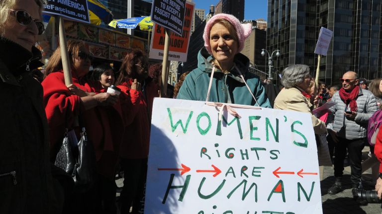 A woman holds a protest sign during the A Day Without a Woman rally in Manhattan on Wednesday, March 8, 2017.