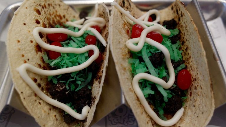 Pop-Tarts Café debuts with pizza, tacos and more in Times Square 8 Cookies & Creme Pop-Tarts masquerade as ground beef, green coconut serves as lettuce and cinnamon jelly beans are the tomatoes. It's all topped with strawberry Sriracha and frosting sour cream inside a cinnamon sugar-dusted corn tortilla. You can buy two for $9.