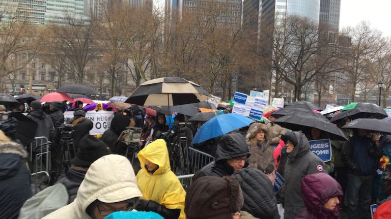 Protesters braved the rain and gathered in Battery Park to attend a rally in support of refugees on Feb. 12, 2017. 