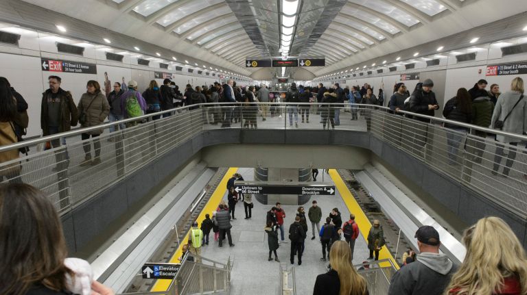 People walk through the Second Avenue subway's 72nd Street station on the first day that the new line opened to the public, Sunday, Jan. 1, 2017.