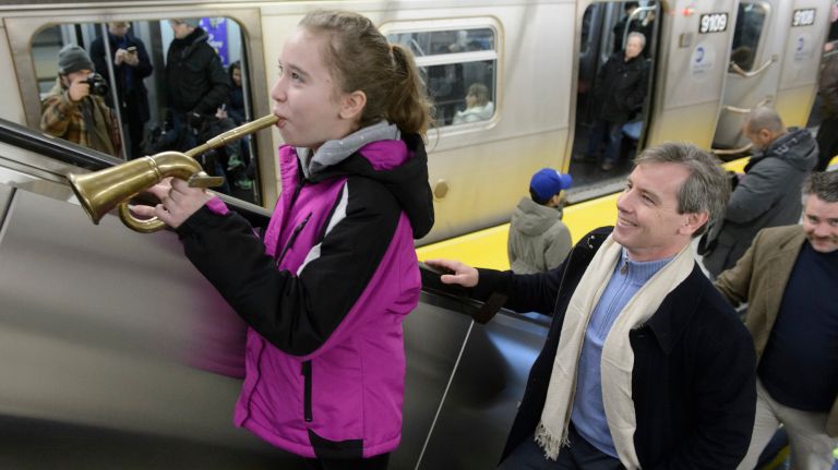 A girl blows her horn at the 96th Street station during the first day of service on the Second Avenue subway on Sunday, Jan. 1, 2017.