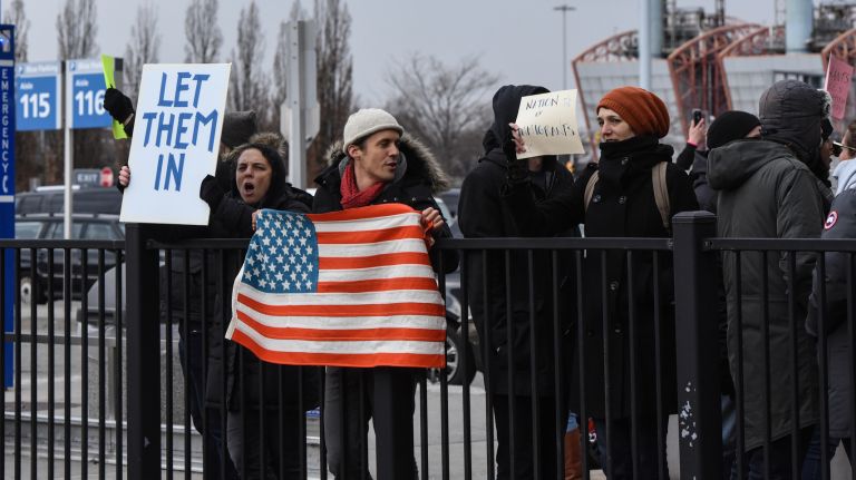 Protesters demand the acceptance of refugees after a new executive order led Iraqi refugees and others to be detained at Kennedy Airport.