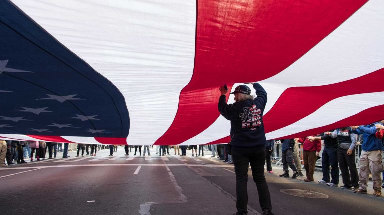 Members of the Ground Zero Volunteer Flag organization walk with a 60x30 foot American Flag.The New York City Veterans Day Parade, also known as America's Parade, on Nov. 11, 2016, marched up Fifth Avenue after a wreath was placed at the Eternal Light Monument at Madison Square Park on 26th St.