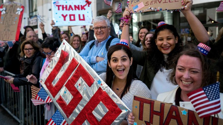 People cheer as veterans and others march up Fifth Avenue during the Veterans Day Parade in Manhattan on Friday, Nov. 11, 2016.