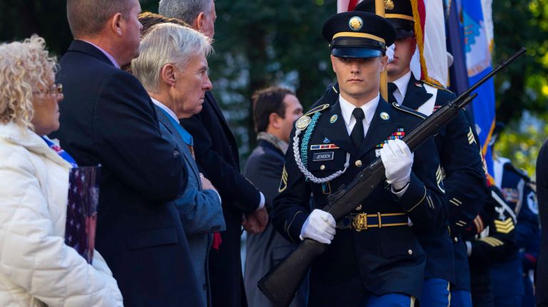 Members of the Honor Guard march on stag as people gather in Madison Square Park for a service before the Veterans Day Parade in Manhattan on Friday, Nov. 11, 2016.