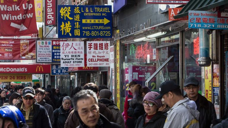 Dual language signs line Main Street in Flushing, a neighborhood with a large Asian population.