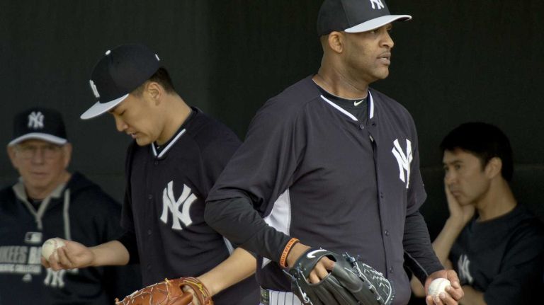 From left, Yankees pitching coach Larry Rothschild, Masahiro Tanaka and CC Sabathia work out in the bullpen at Steinbrenner Field on the morning of Feb. 15, 2014.