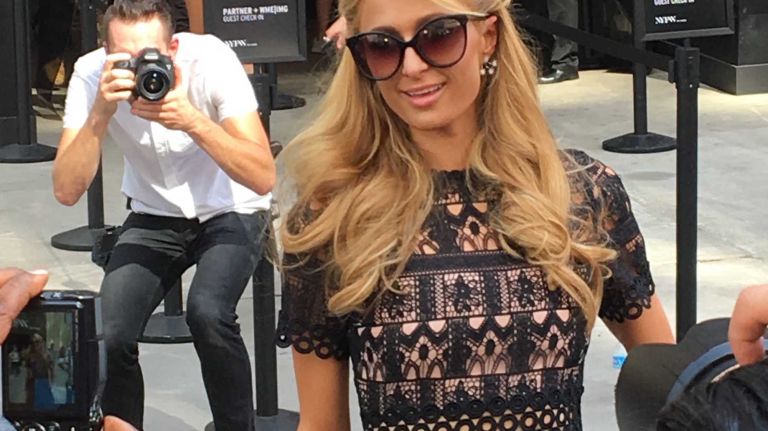 Paris Hilton is all smiles as she leaves the Michael Costello show at Skylight at Moynihan Station in Manhattan during New York Fashion Week on Thursday, Sept. 8, 2016.
