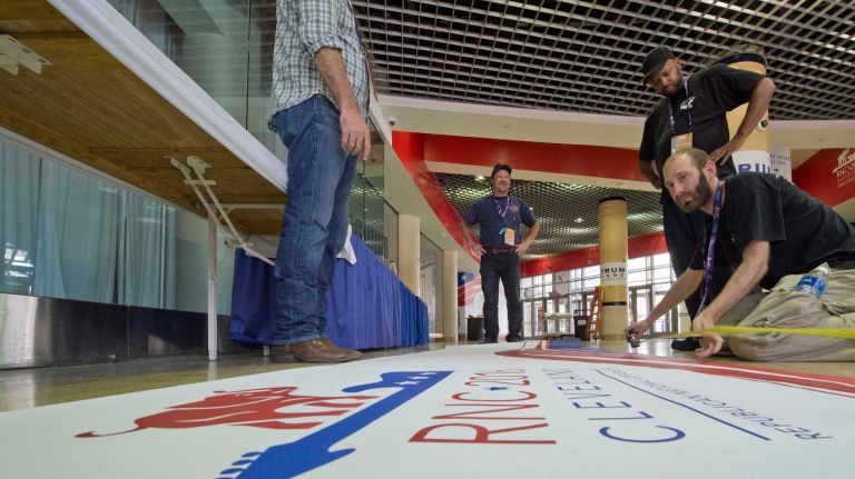Workers prepare the Quicken Loan Arena with signage at the Republican National Convention in Cleveland, Ohio, on Sunday, July 17, 2016.