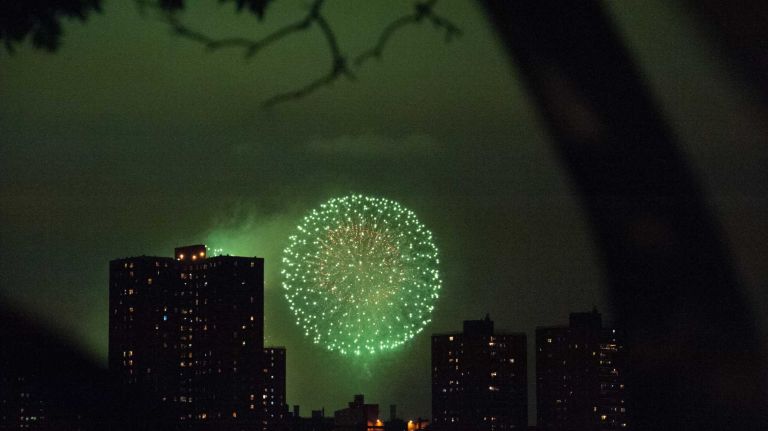 People watch the Macy's 4th of July Fireworks from Brooklyn Bridge Park on July 4, 2016.