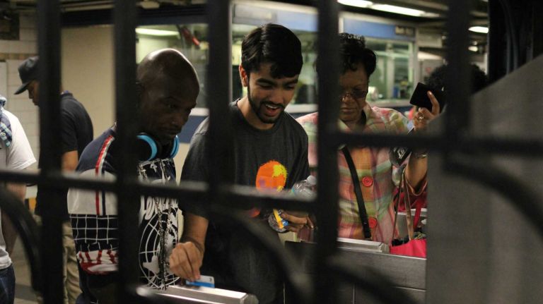 Free subway rides: See photos of protesters in Crown Heights 9 Shayok Chakraborty, of Police Reform Organizing Project, offers a free swipe for a commuter at the Crown Heights-Utica Avenue subway station on Tuesday, June 7, 2016. Chakraborty, was one of about two dozen activists offering free subway rides as part of