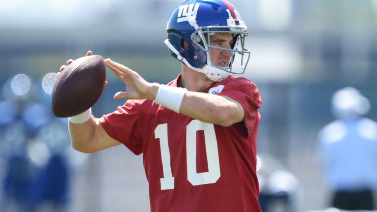 New York Giants quarterback Eli Manning passes the football during the Giants Organized Team Activities at Quest Diagnostics Training Center on Monday, May 23, 2016.