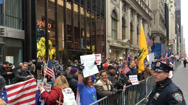 A couple dozen supporters of President Trump hold a rally outside Trump Tower on Sunday, Feb. 5, 2017.