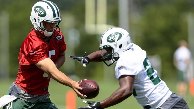 Jets quarterback Christian Hackenberg hands off to running back Romar Morris during the Jets' OTAs on Wednesday, June 1, 2016 in Florham Park, N.J.