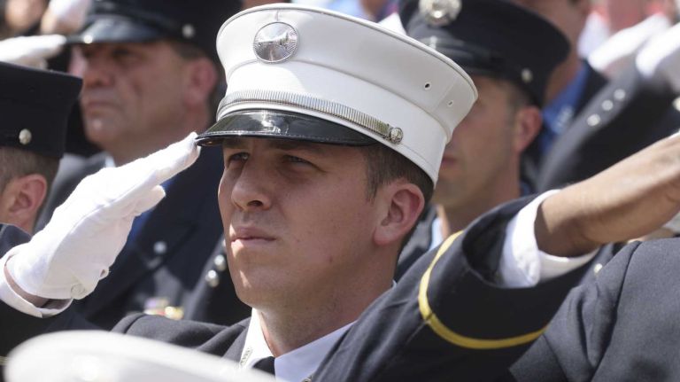 FDNY Lt. John Haseney, center, of West Islip, salutes during the FDNY Medal Day Ceremony in front of City Hall in Manhattan on Wednesday, June 01, 2016. Lt. Haseney, a former member of the New York Army National Guard who was deployed to Afghanistan in 2008, received the Henry D. Brookman Medal for rescuing an woman during a fire in Queens in 2015.