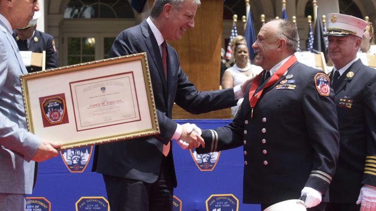 FDNY Capt. James W. Kiesling, of Lindenhurst, shakes hands with New York City Mayor Bill de Blasio after receiving the Captain Denis W. Lane Memorial Medal during the FDNY Medal Day Ceremony in front of City Hall in Manhattan on Wednesday, June 01, 2016. Capt. Kiesling rescued a construction worker who was pinned during a building collapse in Manhattan.