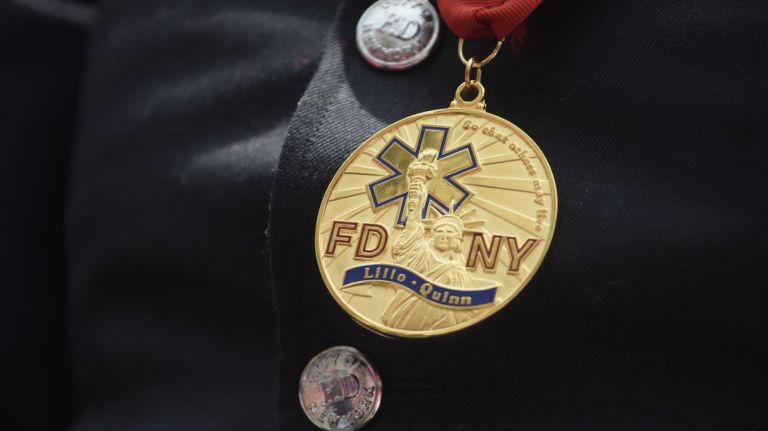 FDNY Paramedic Marilyn Arroyo, of Northport, wears the Paramedic Carlos Lillo/Lieutenant Ricardo Quinn Medal, which was awarded for the first time during the FDNY Medal Day Ceremony in front of City Hall in Manhattan on Wednesday, June 01, 2016. Paramedic Arroyo assisted in the rescue of three people from a submerged car in Queens in 2012.