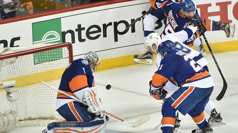 New York Islanders goalie Thomas Greiss (1) tries to make the save on a shot from Tampa Bay Lightning left wing Ondrej Palat (18) in the third period in Game 3 of the Eastern Conference semifinals on Tuesday, May 3, 2016 at Barclays Center.