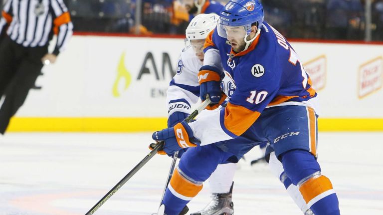 Tampa Bay Lightning left wing Ondrej Palat (18) and New York Islanders center Alan Quine (10) battle for the puck in the second period in Game 3 of the Eastern Conference semifinals on Tuesday, May 3, 2016 at Barclays Center.