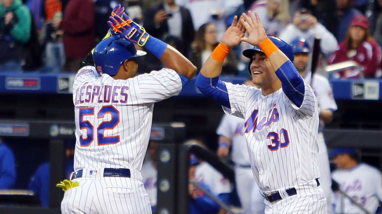 Mets vs. Braves 32 Yoenis Cespedes #52 of the New York Mets celebrates his two-run home run against the Atlanta Braves with teammate Michael Conforto #30 in the first inning of a game at Citi Field on Monday, May 2, 2016.