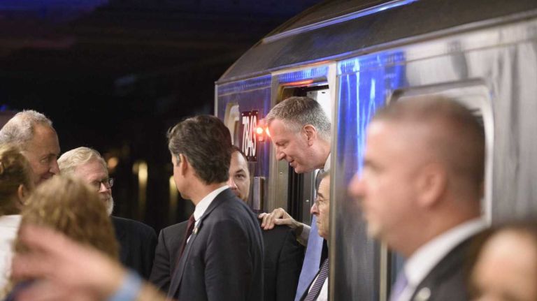 Mayor Bill de Blasio exits a No. 7 train during a ceremony marking the opening of the 34th Street-Hudson Yards station in Manhattan on Sunday, Sept. 13, 2015. 