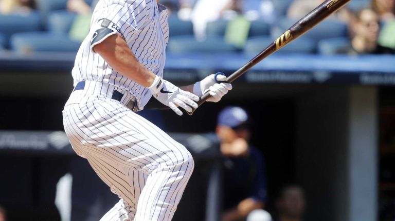 Yankees vs. Rays 110 Jacoby Ellsbury #22 of the New York Yankees follows through on a third inning base hit against the Tampa Bay Rays at Yankee Stadium on Saturday, April 23, 2016 in the Bronx Borough of New York City.