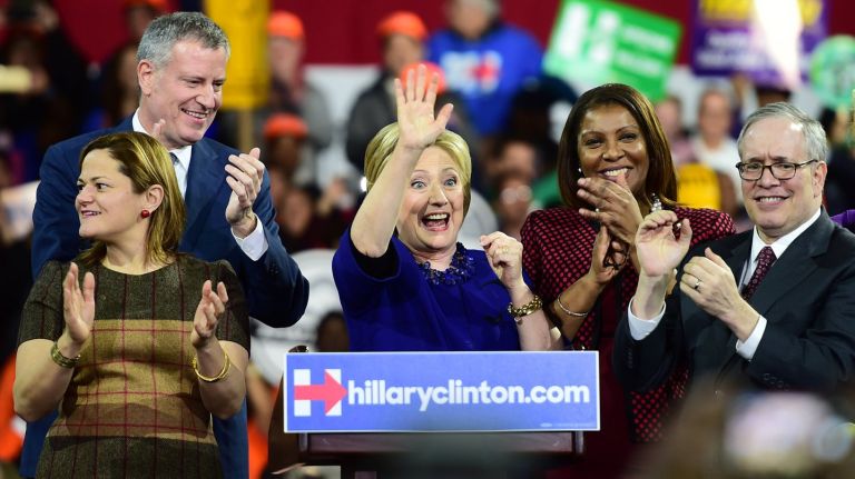 Hillary Clinton would win the New York City mayoral election over incumbent Mayor Bill de Blasio, a new poll found. Above, Clinton, de Blasio and other elected officials rally during a presidential election campaign event.