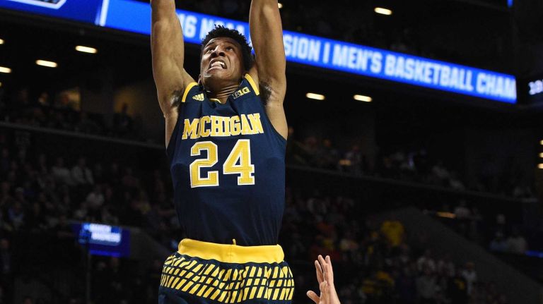NCAA Tournament: Notre Dame vs. Michigan 21 Michigan Wolverines guard Aubrey Dawkins sinks a basket as Notre Dame Fighting Irish forward Matt Ryan defends during the first round of an East Regional men's basketball game in the NCAA Tournament at Barclays Center on Friday, March 18, 2016.