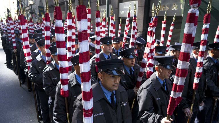 Probationary FDNY firefighters from the academy gather in a unit before stepping off into the St. Patrick's Day Parade Thursday, March 17, 2016, in Manhattan.