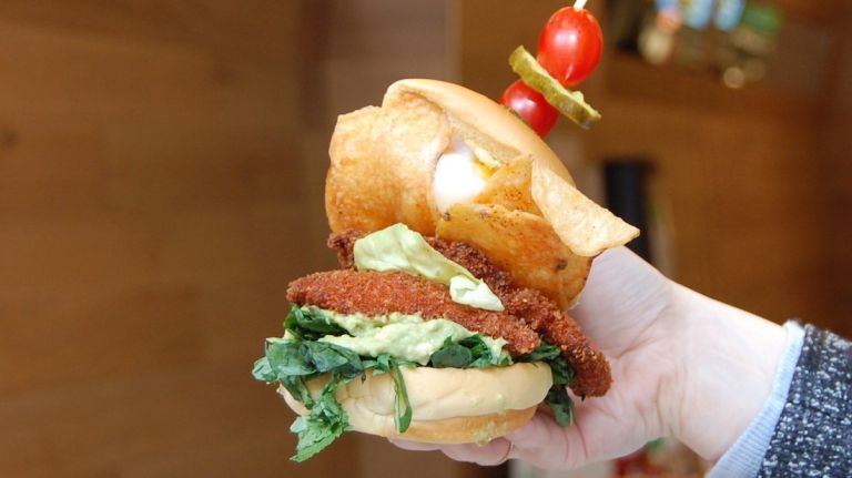 Uncle Sam's in NYC debuts fried chicken sandwich topped with Sriracha potato chips, poached egg 6 The ingredients: Two pieces of panko-crusted fried chicken, one poached egg, crushed avocado, Sriracha potato chips and shredded kale.